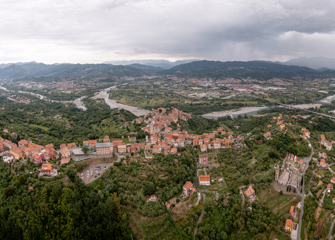 Aerial view of the historic village of Vezzano Ligure nestled in the hills of Liguria featuring traditional stone buildings and a winding river in Vezzano Ligure Liguria Italy.
