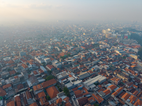 Aerial view of the historic Surabaya old town featuring dense terracotta tiled rooftops and urban architecture in Surabaya East Java Indonesia.
