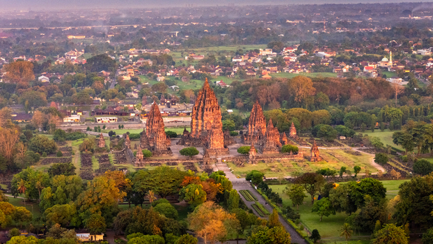 Aerial view of the ancient Prambanan Temple complex with its towering stone spires surrounded by lush greenery in Kecamatan Prambanan Daerah Istimewa Yogyakarta Indonesia. Aerial view of the ancient Prambanan Temple complex with its towering stone spires surrounded by lush greenery in Kecamatan Prambanan Daerah Istimewa Yogyakarta Indonesia.