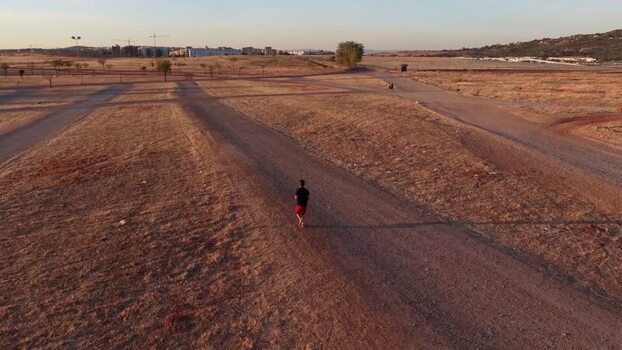 Aerial view of a person walking on a dirt path in Spain.
