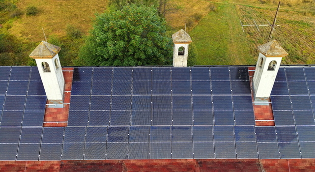 Aerial view of the solar panels installed on the roof of the Brzece Sports Centar featuring traditional chimneys and terracotta tiles in Brzece Rasina District Serbia.