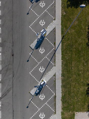 Aerial view of Shell Recharge Charging Station with marked electric vehicle parking spots in a parking lot in Lelystad Flevoland Netherlands. Aerial view of Shell Recharge Charging Station with marked electric vehicle parking spots in a parking lot in Lelystad Flevoland Netherlands.