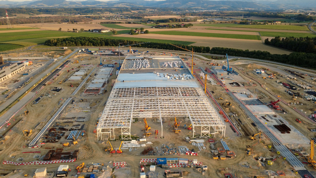 Aerial view of a large data center construction site featuring a steel frame structure multiple cranes and heavy machinery in the rural landscape of Kronstorf Upper Austria Austria. Aerial view of a large data center construction site featuring a steel frame structure multiple cranes and heavy machinery in the rural landscape of Kronstorf Upper Austria Austria.