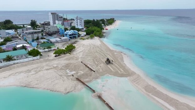 Aerial view of beach construction and turquoise water in Maldives.