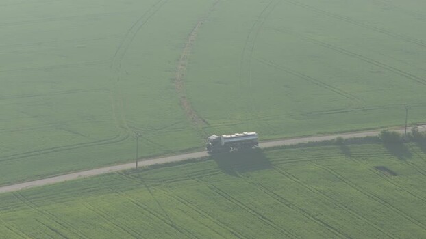 Aerial view of a tanker truck on a road through green fields Czechia. Aerial view of a tanker truck on a road through green fields Czechia.