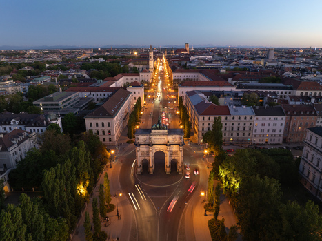 Aerial view of the illuminated Siegestor triumphal arch and Ludwigstrasse at dusk with city lights in Munich Bavaria Germany. Aerial view of the illuminated Siegestor triumphal arch and Ludwigstrasse at dusk with city lights in Munich Bavaria Germany.