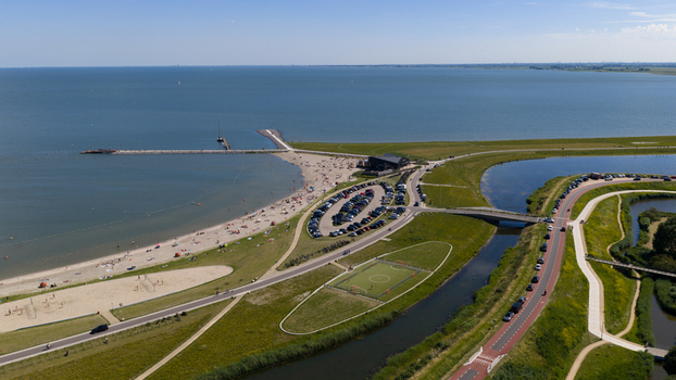 Hoorn Netherlands 20 June 2026 Aerial view of Stadsstrand Hoorn with its sandy beach parking area soccer field and green landscape along the Markermeer lake under a clear sky. Hoorn Netherlands 20 June 2026 Aerial view of Stadsstrand Hoorn with its sandy beach parking area soccer field and green landscape along the Markermeer lake under a clear sky.