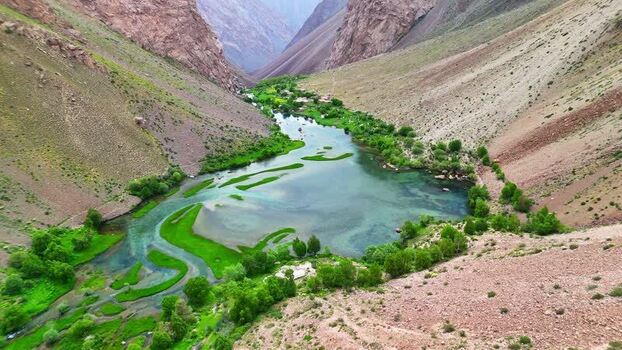 Aerial view of Qullai Vudor peaks and a turquoise lake Tajikistan. Aerial view of Qullai Vudor peaks and a turquoise lake Tajikistan.