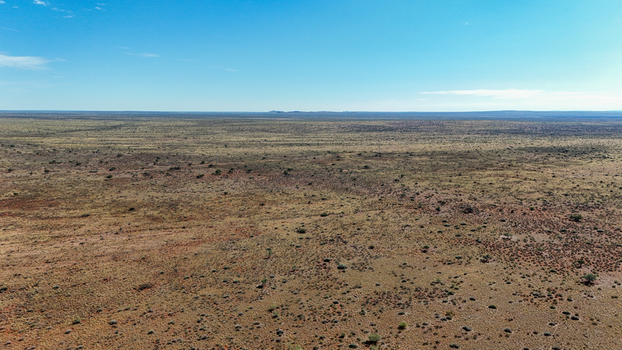 Aerial view of the vast arid landscape stretches to the horizon under a clear blue sky showcasing the stark beauty of the desert Karoo Desert Northern Cape South Africa. Aerial view of the vast arid landscape stretches to the horizon under a clear blue sky showcasing the stark beauty of the desert Karoo Desert Northern Cape South Africa.