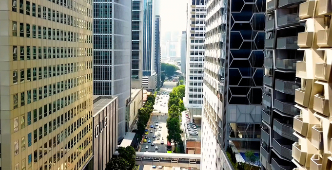 Singapore Singapore 30 September 2026 Aerial view of the dense urban street canyon in the Central Business District of Singapore featuring modern skyscrapers and traffic below.