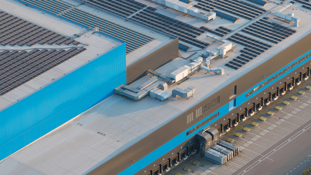 Waalwijk Netherlands 09 May 2026 Aerial view of the Bol.com distribution center featuring a large flat roof covered with solar panels blue and grey industrial walls and loading docks. Waalwijk Netherlands 09 May 2026 Aerial view of the Bol.com distribution center featuring a large flat roof covered with solar panels blue and grey industrial walls and loading docks.