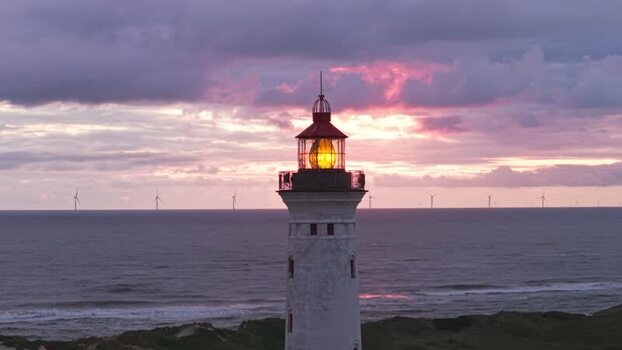 Aerial view of Lyngvig Lighthouse at sunset in Denmark.
