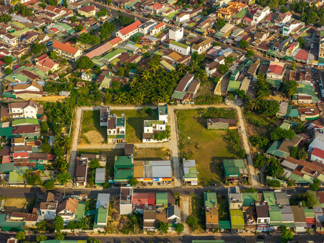 Aerial view of the town of Lien Son Lak near Lak Lake with dense residential rooftops green spaces and local roads in Lien Son Lak Dak Lak Vietnam. Aerial view of the town of Lien Son Lak near Lak Lake with dense residential rooftops green spaces and local roads in Lien Son Lak Dak Lak Vietnam.
