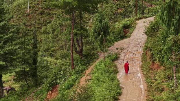 Aerial view of Monk on muddy road Bhutan. Aerial view of Monk on muddy road Bhutan.