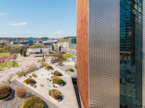 Aerial view of modern architecture and the Chiune Sugihara Sakura Park with blooming cherry trees and people in Vilnius Vilniaus apskritis Lithuania. Aerial view of modern architecture and the Chiune Sugihara Sakura Park with blooming cherry trees and people in Vilnius Vilniaus apskritis Lithuania.