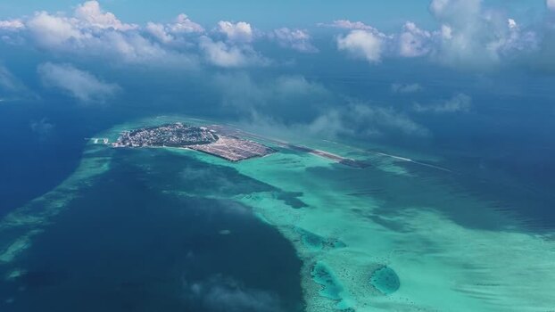 Aerial view of Kudahuvadhoo island and airport Maldives. Aerial view of Kudahuvadhoo island and airport Maldives.