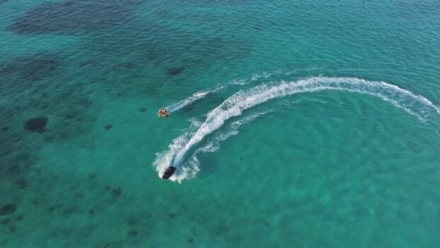 Aerial view of a jet ski towing an inflatable tube Maldives. Aerial view of a jet ski towing an inflatable tube Maldives.