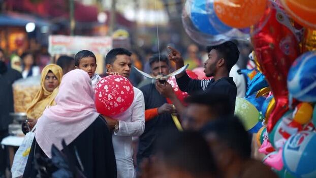 View of people and colorful balloons at a street market Bangladesh. View of people and colorful balloons at a street market Bangladesh.