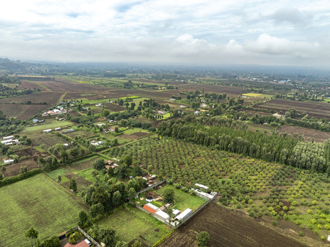 Aerial view of lush green fields and scattered settlements under a cloudy sky create a serene landscape Nyeri Nyeri Kenya. Aerial view of lush green fields and scattered settlements under a cloudy sky create a serene landscape Nyeri Nyeri Kenya.
