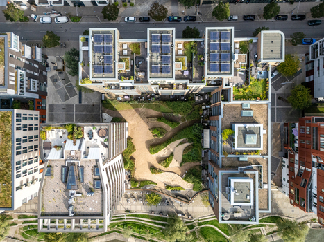 Aerial view of modern residential buildings with green rooftops solar panels and a central landscaped courtyard in Hamburg Germany.