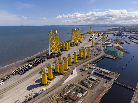 Edinburgh United Kingdom 06 May 2026 Aerial view of Leith docks featuring yellow offshore wind turbine foundations along the industrial coastline under a blue sky. Edinburgh United Kingdom 06 May 2026 Aerial view of Leith docks featuring yellow offshore wind turbine foundations along the industrial coastline under a blue sky.