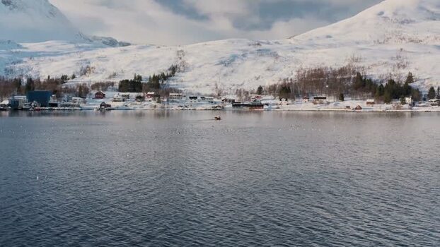 View of Botnhamn village and snowy mountains Norway.