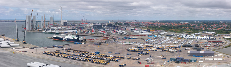 Esbjerg Denmark 24 July 2026 Aerial view of Esbjerg Port featuring Vestas wind turbine components a DFDS cargo ship docked at the quay and rows of trucks in the industrial logistics area.