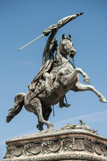 View of the Archduke Charles Monument featuring an equestrian statue on a rearing horse against a clear blue sky in Vienna Austria. View of the Archduke Charles Monument featuring an equestrian statue on a rearing horse against a clear blue sky in Vienna Austria.