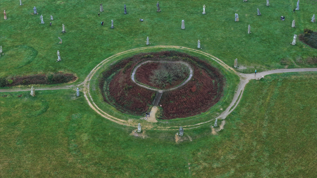 Carnoet France 26 December 2023 Aerial view of the Valley of Saints featuring the circular mound and granite statues scattered across the green landscape. Carnoet France 26 December 2023 Aerial view of the Valley of Saints featuring the circular mound and granite statues scattered across the green landscape.