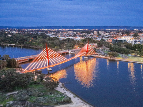 Aerial view of Boorloo Bridge illuminated at twilight with the Swan River and the East Perth cityscape in the background East Perth Western Australia Australia.