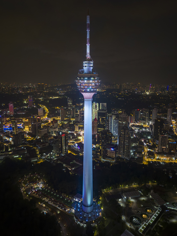 Kuala Lumpur Malaysia 11 March 2026 Aerial view of Menara Kuala Lumpur illuminated at night against the city skyline with glowing street lights and dark sky.