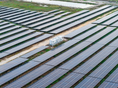 Aerial view of a large scale solar photovoltaic power plant with rows of solar panels and a central power station unit in Central Seberang Perai Penang Malaysia. Aerial view of a large scale solar photovoltaic power plant with rows of solar panels and a central power station unit in Central Seberang Perai Penang Malaysia.