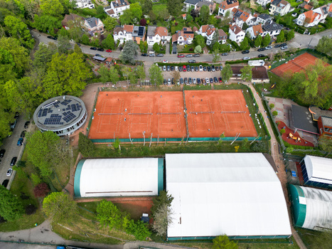 Aerial view of red clay tennis courts and sports facilities surrounded by green trees and residential houses in Woluwe Saint Lambert Bruxelles Belgium. Aerial view of red clay tennis courts and sports facilities surrounded by green trees and residential houses in Woluwe Saint Lambert Bruxelles Belgium.