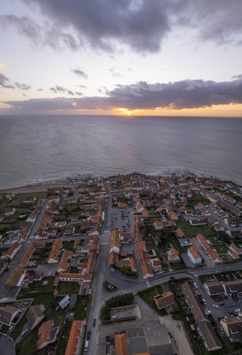 Aerial view of the coastal village of Audresselles with its traditional rooftops narrow streets and the sea at sunset in Audresselles Hauts de France France.
