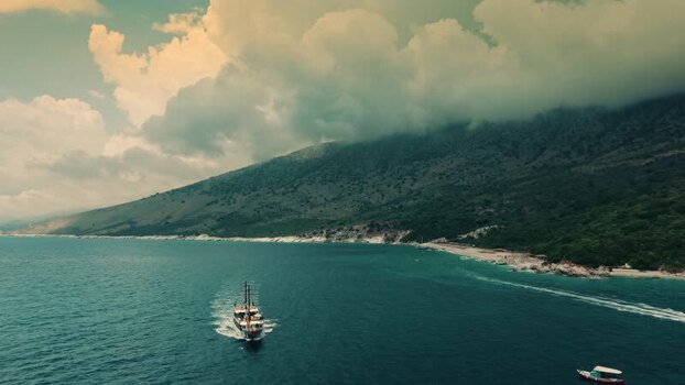 Aerial view of a boat cruising along the coast of Albania. Aerial view of a boat cruising along the coast of Albania.