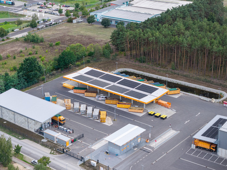 Aerial view of the KWU Entsorgung Wertstoffhof Freienbrink recycling depot featuring solar panels on the roof waste containers and service vehicles in Grunheide Mark Brandenburg Germany. Aerial view of the KWU Entsorgung Wertstoffhof Freienbrink recycling depot featuring solar panels on the roof waste containers and service vehicles in Grunheide Mark Brandenburg Germany.