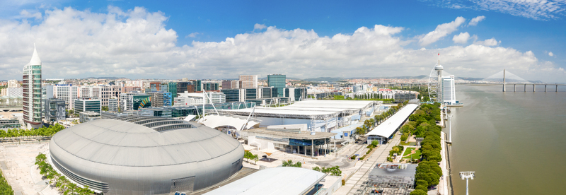 Aerial view of a modern cityscape where the Tagus River reflects the sky contrasting with the sleek lines of contemporary architecture Lisbon Portugal.