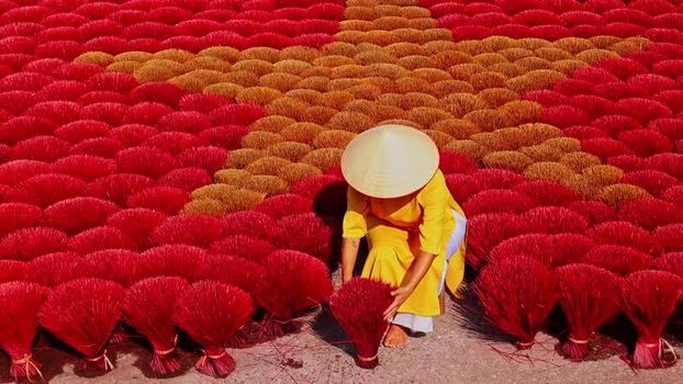 View of a person working with incense sticks Vietnam.