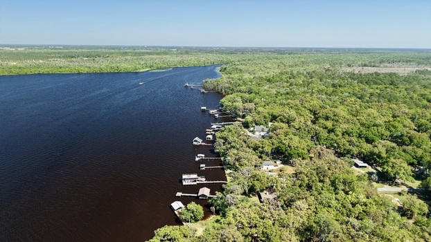 Aerial view of the dark waters snaking past the dense verdant forest meeting the docks and dwellings along Palmo Fish Camp Road St. Augustine Florida United States. Aerial view of the dark waters snaking past the dense verdant forest meeting the docks and dwellings along Palmo Fish Camp Road St. Augustine Florida United States.