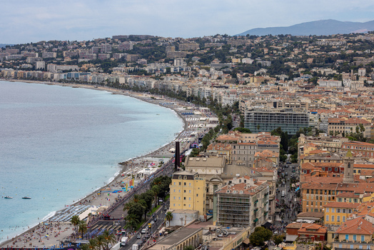 Aerial view of the Promenade des Anglais coastline in Nice featuring the turquoise Mediterranean Sea beach umbrellas and historic urban architecture Nice Provence Alpes Cote d Azur France. Aerial view of the Promenade des Anglais coastline in Nice featuring the turquoise Mediterranean Sea beach umbrellas and historic urban architecture Nice Provence Alpes Cote d Azur France.