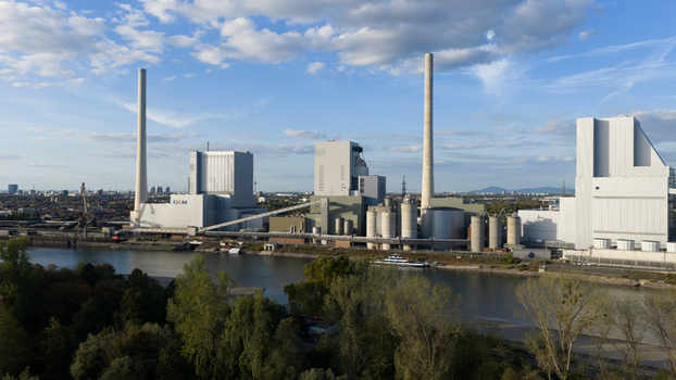 Aerial view of the Grosskraftwerk Mannheim power plant with tall chimneys and industrial buildings situated along the riverbank in Mannheim Baden Wurttemberg Germany.