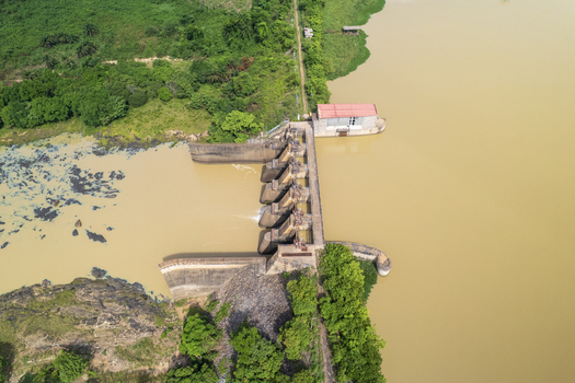 Aerial view of the Asejire Dam its concrete structure stark against the muddy water and vibrant green vegetation Asejire Oyo Nigeria. Aerial view of the Asejire Dam its concrete structure stark against the muddy water and vibrant green vegetation Asejire Oyo Nigeria.