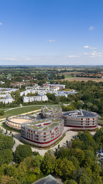 Durmersheim Germany 12 September 2026 Aerial view of Wilhelm Hausenstein Gymnasium with its distinctive cloverleaf architecture green roofs and solar panels surrounded by trees.