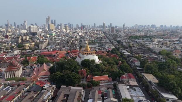 Aerial view of Wat Saket and the city skyline in Bangkok Thailand.