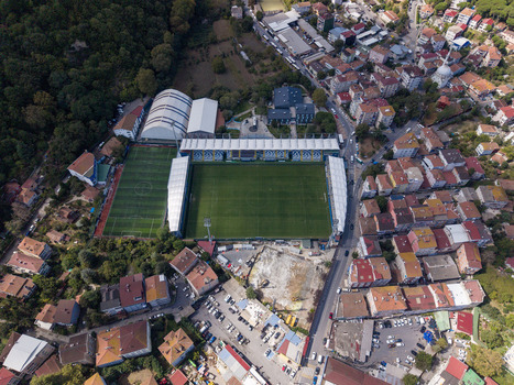 Aerial view of Yusuf Ziya Onis Stadium surrounded by residential buildings and lush greenery in Istanbul Istanbul Turkiye. Aerial view of Yusuf Ziya Onis Stadium surrounded by residential buildings and lush greenery in Istanbul Istanbul Turkiye.