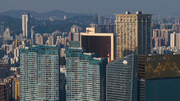 Macao 18 February 2026 Aerial view of the Macau skyline featuring the MGM Macau hotel with its gold facade surrounded by dense high rise skyscrapers under a clear sky. Macao 18 February 2026 Aerial view of the Macau skyline featuring the MGM Macau hotel with its gold facade surrounded by dense high rise skyscrapers under a clear sky.