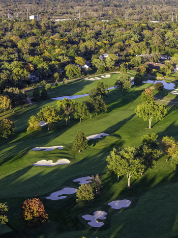 Aerial view of a golf course in autumn with vibrant fall foliage sand traps and a small pond in Glenview Illinois United States. Aerial view of a golf course in autumn with vibrant fall foliage sand traps and a small pond in Glenview Illinois United States.