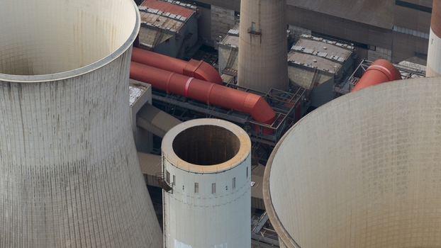 Aerial view of Kraftwerk Niederaussem showing large cooling towers and industrial pipes in Bergheim Nordrhein Westfalen Germany. Aerial view of Kraftwerk Niederaussem showing large cooling towers and industrial pipes in Bergheim Nordrhein Westfalen Germany.
