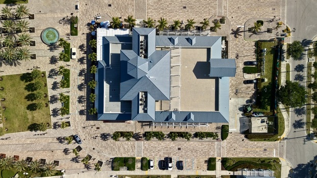 Aerial view of Riviera Beach Marina Village with its blue grey rooftops surrounding paved plaza palm trees and a circular fountain in Riviera Beach Florida United States. Aerial view of Riviera Beach Marina Village with its blue grey rooftops surrounding paved plaza palm trees and a circular fountain in Riviera Beach Florida United States.