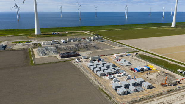 Espel Netherlands 04 April 2026 Aerial view of the Westermeerdijk wind farm and power substation with offshore turbines in the IJsselmeer and battery storage units on land.